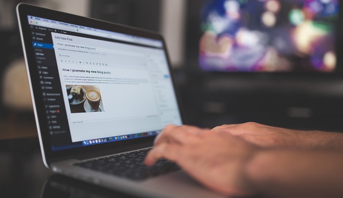 Small business owner using WordPress to manage a website Small business owner using WordPress to manage a website